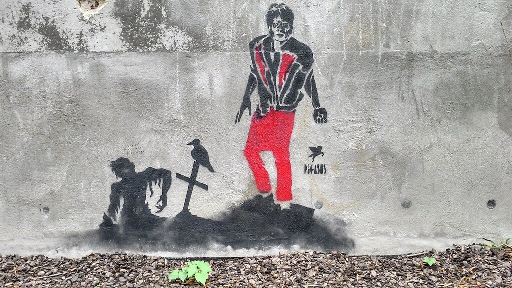 A street art depiction of Michael Jackson in his iconic 'Thriller' music video pose.
